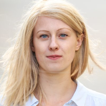 A fair-haired woman with blue eyes and a white collared shirt looks directly at the camera with a subtle, confident expression. Her professional appearance aligns with the post, suggesting she is likely Ripple executive Azzi Cooper, pictured alongside news about XRPL's new AI Starter Kit for agentic payments.