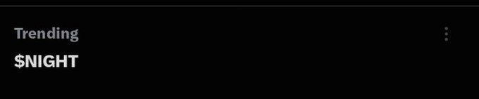 A simple black screen with white text reading 'Trending $NIGHT' and a three-dot menu icon in the upper right corner.