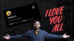 A man with arms outstretched stands before a black backdrop with the text 'I LOVE YOU ALL' in red, next to a social media profile for 'VIKING' (@itsKingViking) showing 3.29K followers and 1,999 following.
