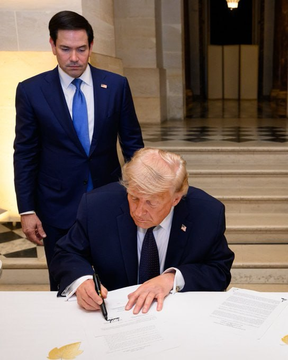 President Donald Trump signs legislation at a formal White House ceremony, with Secretary of State Marco Rubio standing behind him, in an image accompanying news that the CLARITY Act has passed committee review—legislation that could provide long-awaited regulatory clarity for digital assets like XRP.