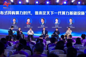 The image shows a group of people sitting around a table for an event where they are discussing the integration of Artificial Intelligence (AI) and cryptocurrency. The attendees include individuals from various backgrounds such as business, technology, and education. They are seated on chairs arranged in rows facing each other, with some standing to emphasize their points during the discussion.

The room is well-lit, creating a professional atmosphere for the event. There are several people present, including those sitting at the front of the room and others scattered around the space. The attendees appear engaged in the conversation, contributing to an interactive and dynamic environment.