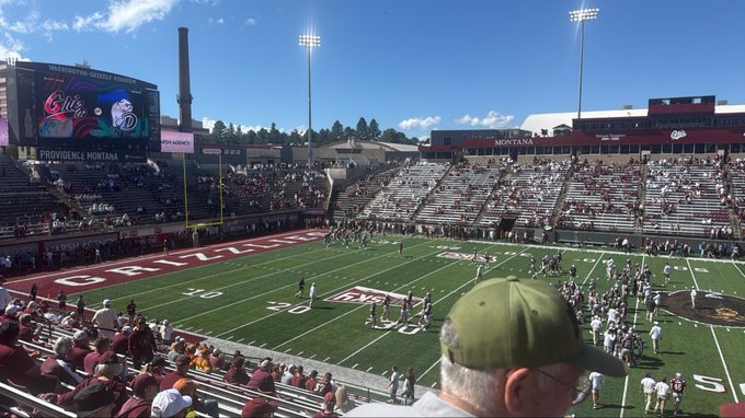 Fans fill Washington-Grizzly Stadium during a Montana Grizzlies football game, with the scoreboard displaying 'PROVIDENCE' versus Montana.