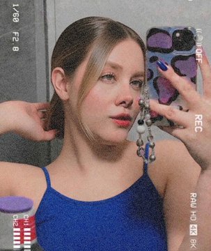 A mirror selfie of a woman with reddish-blonde hair holding a phone with a purple case, wearing a blue tank top and beaded phone charm, captured with a 'Rec' recording effect overlay.