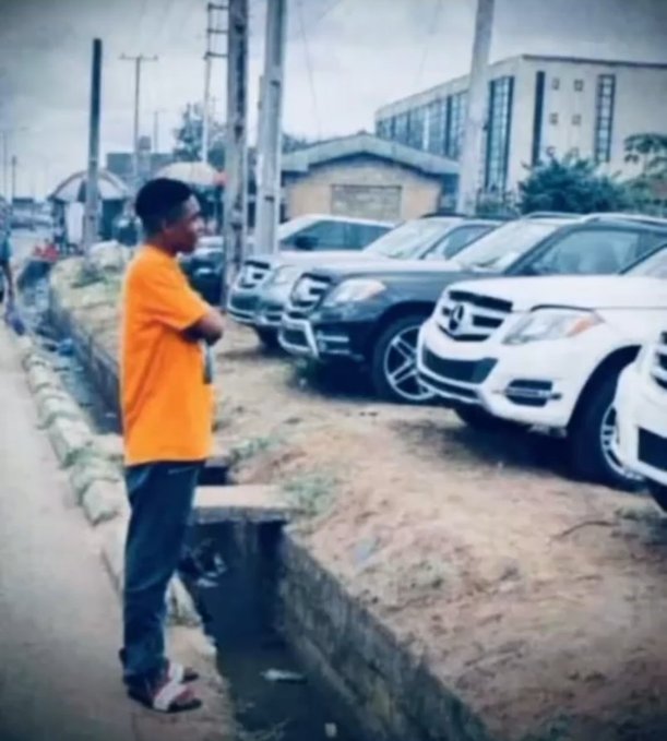 A photo shows a young man in an orange shirt standing on a dirt path beside a row of parked luxury SUVs (Mercedes, Toyota).