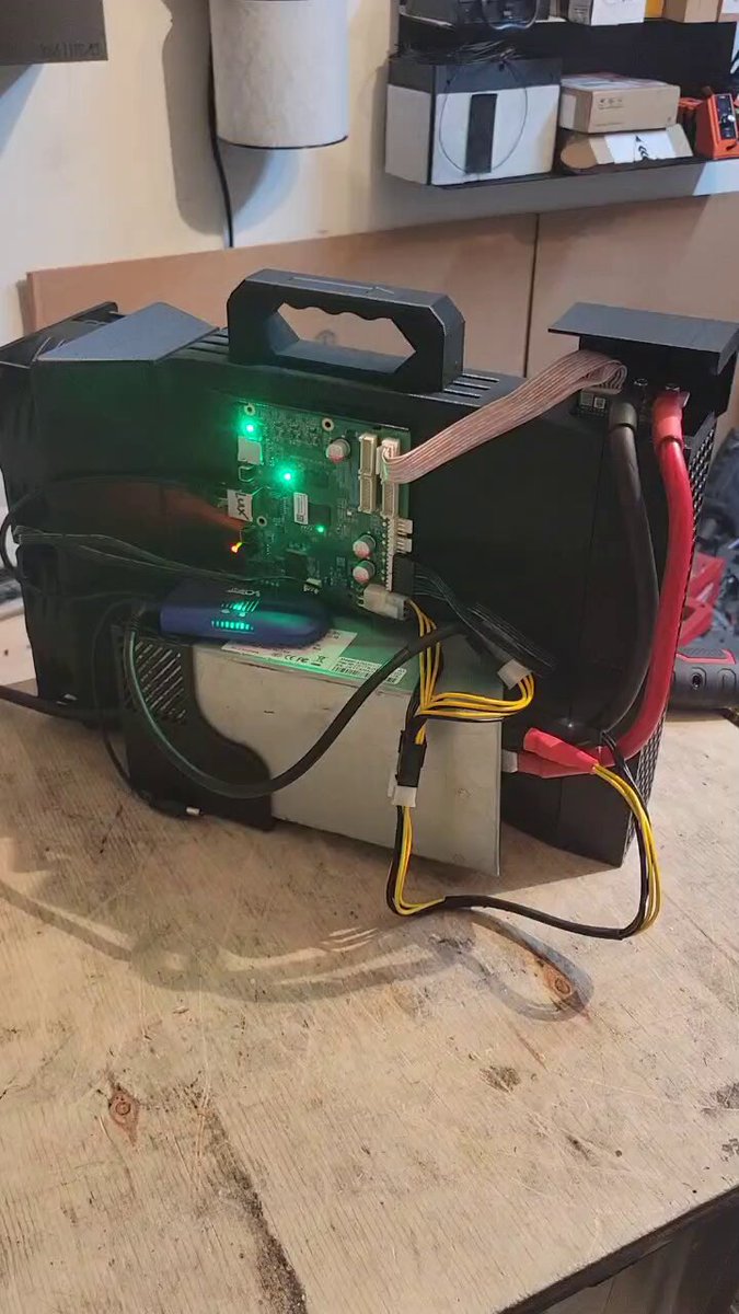 The image shows an open computer case with various components, including wires and cables. The main focus of the image is a green light coming from inside the computer case. There are also other objects present in the scene, such as a keyboard on the right side and a mouse near the center. The post seems to be discussing the intricacies of the computer's internal workings or possibly an interesting DIY project involving the components of the computer case.