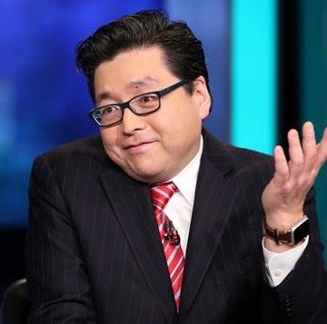 A man in a pinstripe suit and red striped tie gestures with his hand during what appears to be a televised interview or panel discussion, possibly providing commentary on BitMine's significant Ethereum holdings and staking statistics.