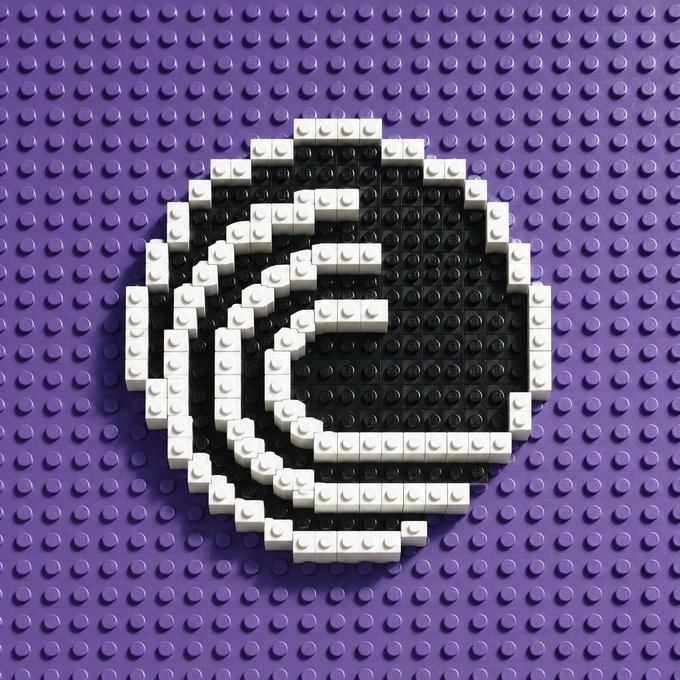 A LEGO interpretation of the Epic Games 'e' logo, rendered in white bricks against a purple studded baseplate.