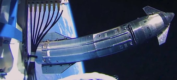 A metallic, cylindrical spacecraft or satellite component floats in space above Earth.
