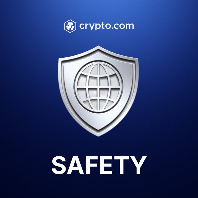 A Crypto.com advertisement displays their silver globe shield logo with the word 'SAFETY' prominently featured against a blue gradient background.
