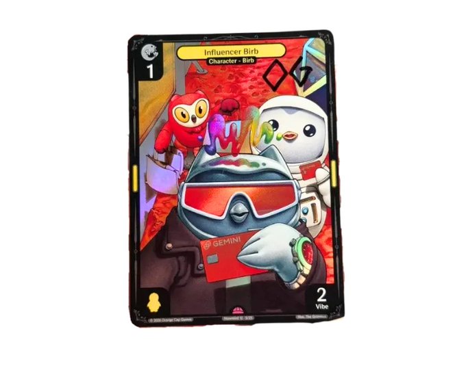 A trading card titled 'Influencer Birb' featuring a cat character wearing ski goggles and holding a Gemini credit card, with character types 'Birb' and '2 Vibe'.