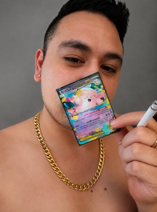 A shirtless man wearing a gold chain and holding a cigarette poses while holding up a holographic Clefairy Pokémon card (50 HP, Psychic-type, "Metronome" attack) in front of his face, showing off his new TCG collectible with a satisfied expression.