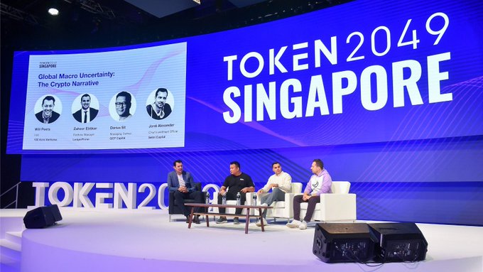 A panel discussion at TOKEN 2049 Singapore titled 'Global Macro Uncertainty: The Crypto Narrative' featuring speakers Will Points, Zaheer Ebtikar, Doran M, and Jose Fernandez.