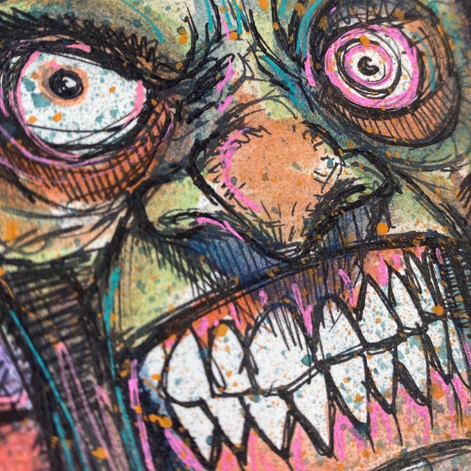 A close-up of a colorful, chaotic ink illustration of a monstrous face with wide eyes, a large nose, and a toothy grin rendered in pinks, blues, and oranges.