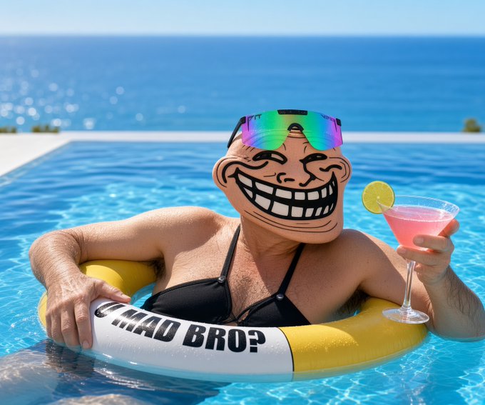An AI-generated image of a person floating in a pool on a yellow inner tube, wearing rainbow sunglasses, with a trollface mask overlaid on their face, holding a pink cocktail, with text on the tube reading 'MAD BRO?'.