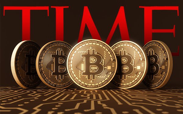 Five physical Bitcoin coins are displayed standing up against a red background featuring the word "TIME" in large red letters, resting on a circuit board surface.