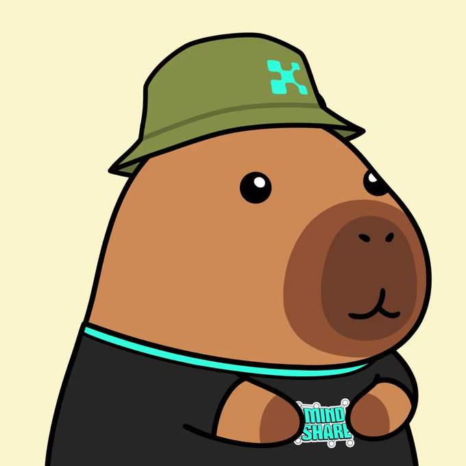 The image shows a cartoon capybara wearing a green KaitoAI bucket hat and a black shirt, holding a "MIND SHARE" badge. The illustration visually represents the "Yapybara" mascot the post mentions, with the KaitoAI hat directly tying into the user's preparation for the new @KaitoAI season focused on earning mindshare.