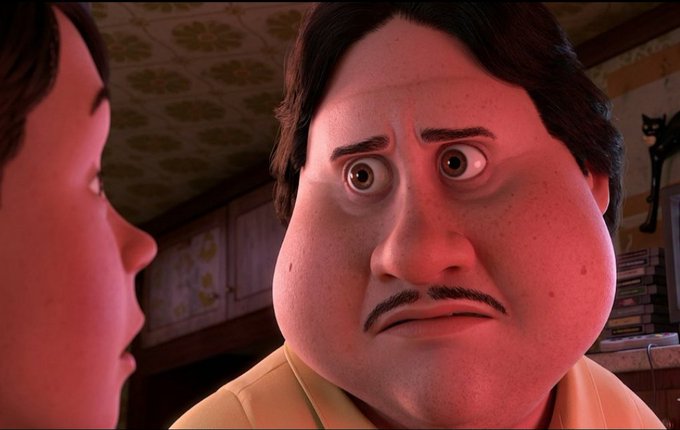An animated scene featuring a round-faced character with dark hair and mustache looking surprised, illuminated by red lighting, with another person visible in profile on the left.