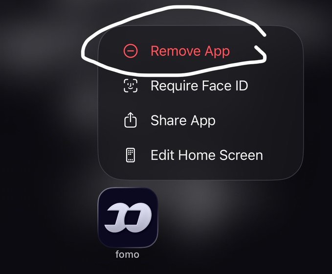 The image shows an iOS context menu for an app called "fomo" with the "Remove App" option circled in white, alongside options to "Require Face ID," "Share App," and "Edit Home Screen." The image humorously illustrates the post's advice to stop losing money on memecoins by suggesting users literally remove the FOMO app—FOMO standing for "Fear of Missing Out," a key emotion driving impulsive memecoin trading losses.