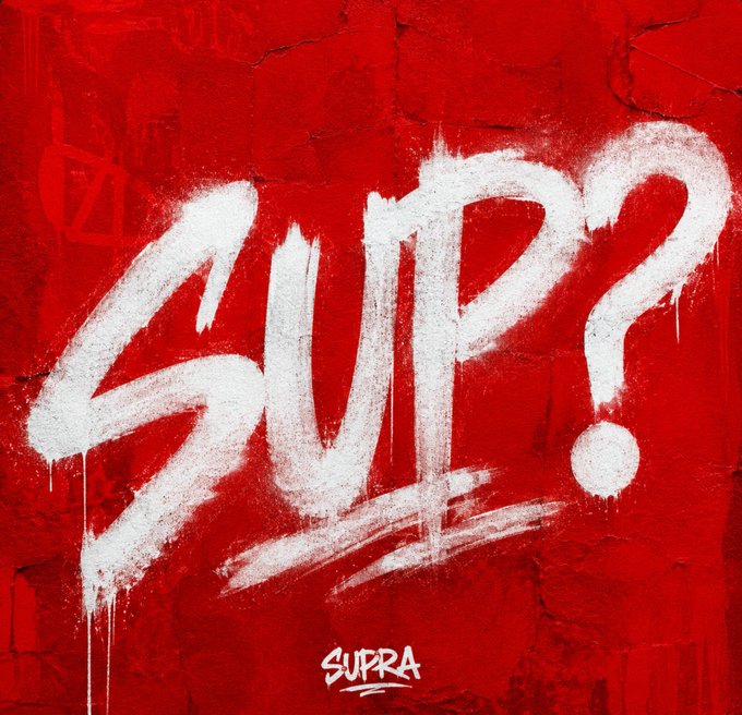 The artwork displays the word "SUP?" spray-painted in white graffiti with dripping paint on a vibrant red textured wall, with the "SUPRA" logo positioned at the bottom center. The image visually reinforces the casual, community-focused prompt "SUP?" by transforming it into street art-style branding for the SUPRA community.