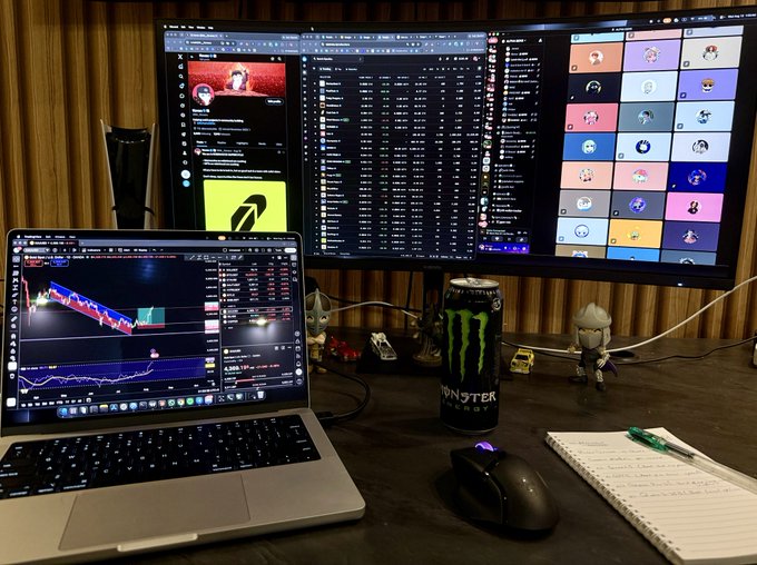 A dedicated trader's workstation at 4am, featuring a laptop running trading charts alongside a curved monitor displaying OpenSea NFT listings and what appears to be a chat with @0xAlphaGEMs, fueled by a Monster energy drink and surrounded by small figurines—capturing the bullish crypto/NFT market vibe described in the post.
