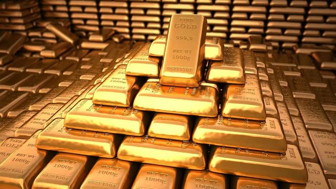 A 3D render showing a large pyramid stack of shiny gold bars labeled 'FINE GOLD 999.9 NET WT 1000g' surrounded by more gold bars.
