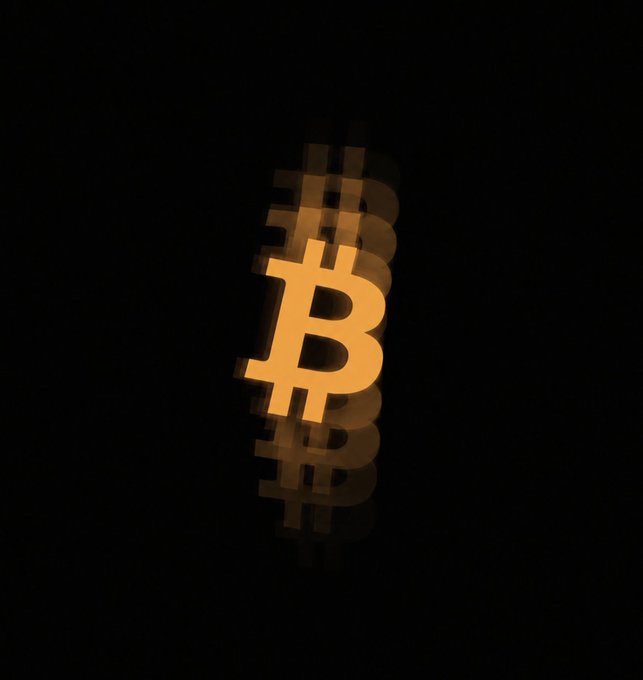 A glowing orange Bitcoin symbol is shown with a motion blur effect against a dark background.