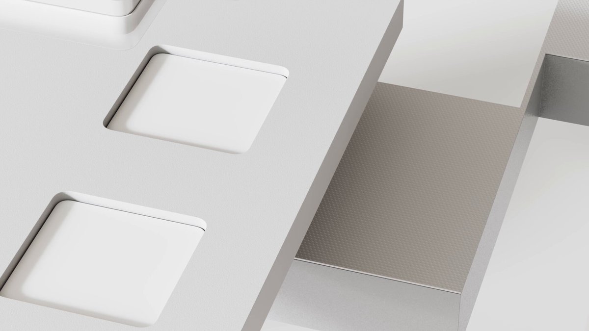 The image shows a close-up view of a white surface with three square cutouts arranged in a row. The cutouts are positioned at different angles, creating an interesting visual effect. The background appears to be a light gray color, which contrasts nicely with the white surface and makes the cutouts stand out more prominently. The image does not contain any text or additional objects, so it focuses solely on the three square cutouts and their arrangement.