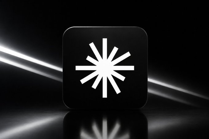 A black rounded-square app icon featuring a white, starburst-like logo consisting of radiating lines of varying lengths, set against a glossy black background with light streaks.