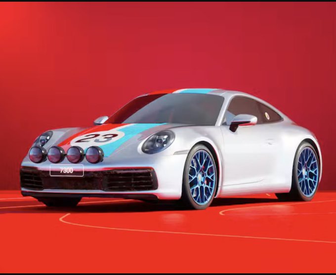 A silver Porsche 911 with blue and red racing stripes and the number 23 on the hood is displayed against a vibrant red background.