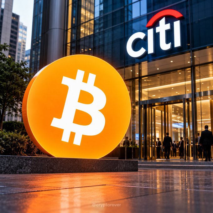 A large, glowing orange Bitcoin coin sits on a reflective surface in front of a 'Citi' bank's glass entrance, with the watermark '@cryptorover' visible at the bottom.