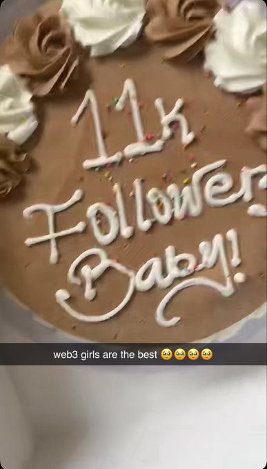 A chocolate birthday cake decorated with white and brown frosting rosettes is inscribed with '11k Followers Baby!' in white icing, with a caption reading 'web3 girls are the best' with smiley emojis.