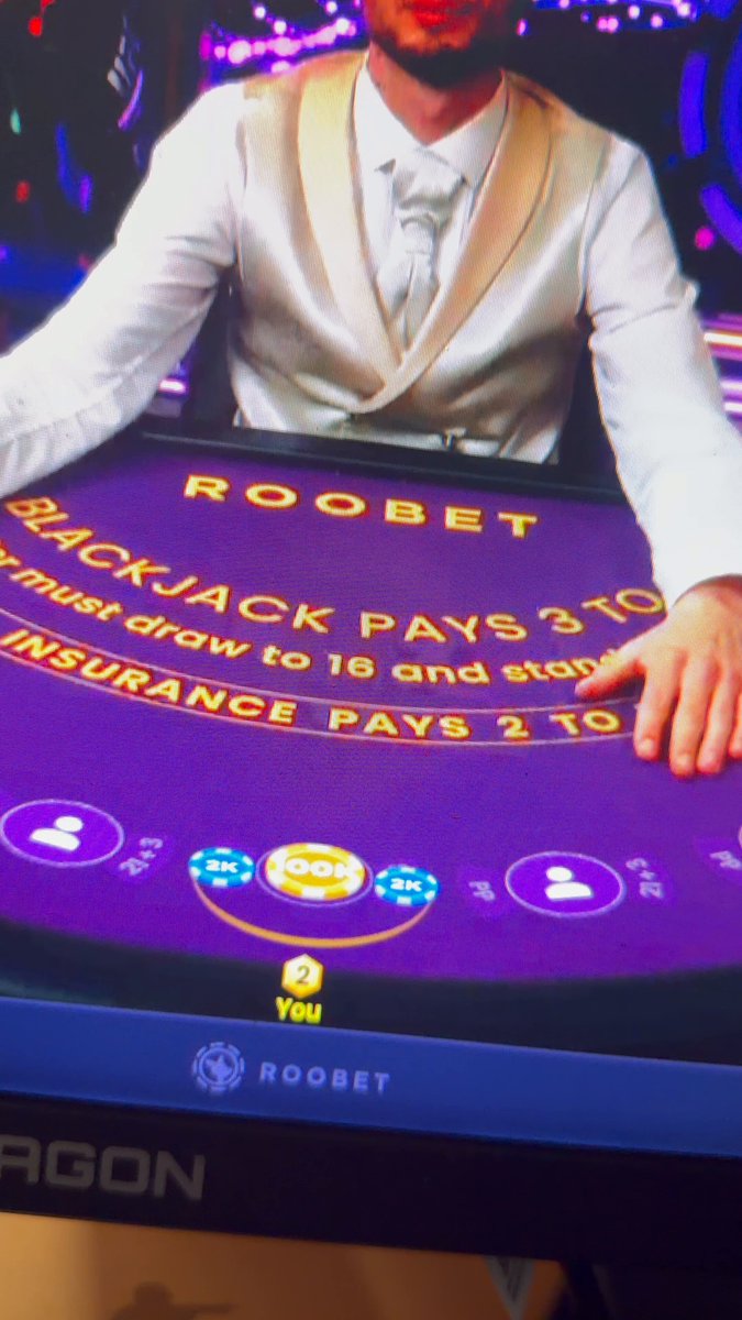 The image shows a man wearing a vest sitting behind a poker table with a purple surface. The man appears to be playing blackjack, as he is holding a card up for all to see. There are several other cards visible on the table, indicating that this could be an ongoing game or a practice session. The post about Solana loss and hands being ripped out of the virtual wallet suggests that someone might have been involved in a gambling activity, possibly online, where they lost money due to a bet or a risky decision.