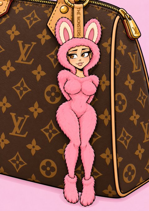 A pink, furry bunny character wearing a hood with ears is attached to a brown Louis Vuitton monogram bag, featuring a leather tag that reads "THE MONSTERS".