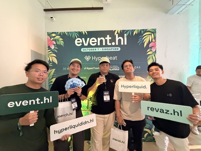 A group of five people pose together at the 'event.hl' event in Singapore (October 7), holding signs that read 'event.hl', 'hyperliquididn.hl', 'Hyperliquid.', and 'revaz.hl' in front of a leafy tropical backdrop.