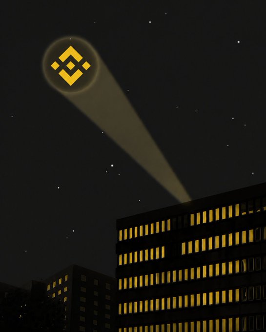A spotlight projects the glowing Binance logo into the night sky above illuminated city buildings, evoking the brand's dominant presence in the crypto world. The image visually reinforces the "SuperApp you need" tagline by positioning Binance as a bright, guiding beacon for users seeking an all-in-one financial platform.