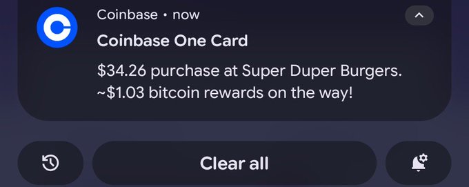 A Coinbase notification reads “Coinbase One Card,” “$34.26 purchase at Super Duper Burgers,” and “~$1.03 bitcoin rewards on the way!”