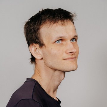 urn of water, a man with short brown hair and blue eyes, wearing a purple shirt against a white background.