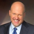 A bald man in a suit and tie smiles broadly in a professional headshot, identified as Jim Cramer, the financial commentator who is publicly endorsing the purchase of Bitcoin.