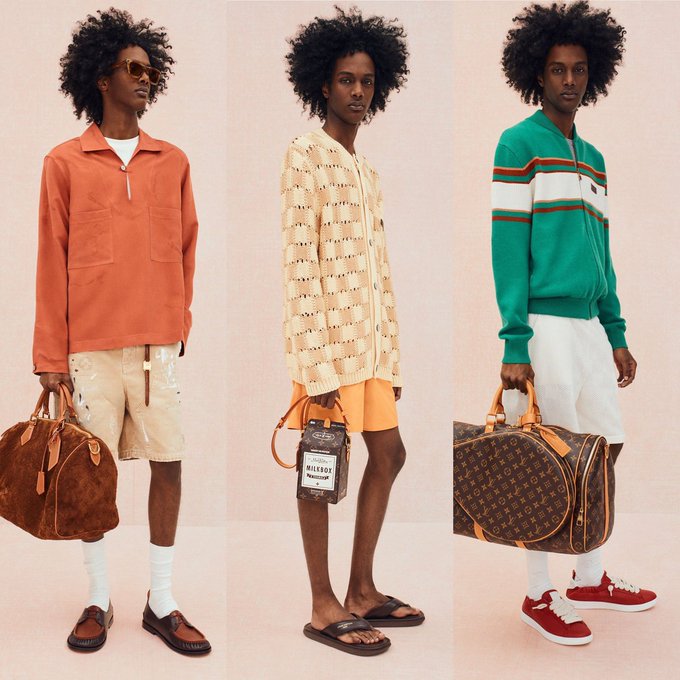 Three side-by-side full-body portraits of a model with curly afro hair showcase different luxury outfits against a pink backdrop: an orange pullover with beige shorts carrying a brown monogram duffel bag, a cream knit cardigan with orange shorts and flip-flops carrying a "Mile" leather satchel, and a green color-blocked zip-up sweater with white shorts and red sneakers carrying a Louis Vuitton monogram duffel bag.