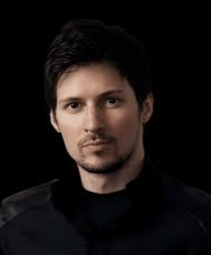 The image features a man with short hair wearing a black jacket, looking directly at the camera. The background of the photo is black, which contrasts with the white text that reads "JUST IN: Community vote live on TON rebrand to GRAM. Telegram suggests original whitepaper name following 10× speed and 6× lower fee improvements". This image seems to be related to a discussion or event about a new cryptocurrency called "TON" as suggested by the post, which is likely aimed at raising awareness or promoting the project among the community.