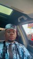 Low-resolution selfie of a person wearing sunglasses and a patterned shirt.