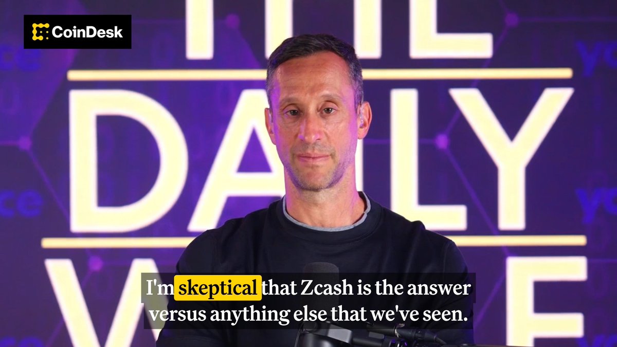 The image features a man standing against a purple background with a sign that reads "The Daily Value" above him. Below this, there are two lines of text written by someone else, which seem to be discussing ZCash and Bitcoin. The main focus is on the man in front of the sign, who appears to be posing for the photo or participating in an interview related to the topic at hand.