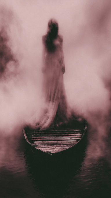 An atmospheric, misty, monochromatic image of a ghostly figure in a long dress standing in a wooden rowboat on water, rendered with motion blur.