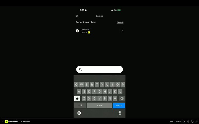 A mobile screenshot of the Robinhood app shows a search interface with "Cash Cat" ($CASHCAT) as the only recent search result, appearing at the 38:42 mark of a Q2 2026 earnings live stream. The post highlights this quirky moment when Vlad Tenev demonstrated the wallet's search function during the broadcast.