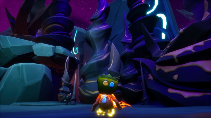 A video game screenshot shows a small green bird-like character with glowing feet standing in a dark, rocky landscape with purple skies.