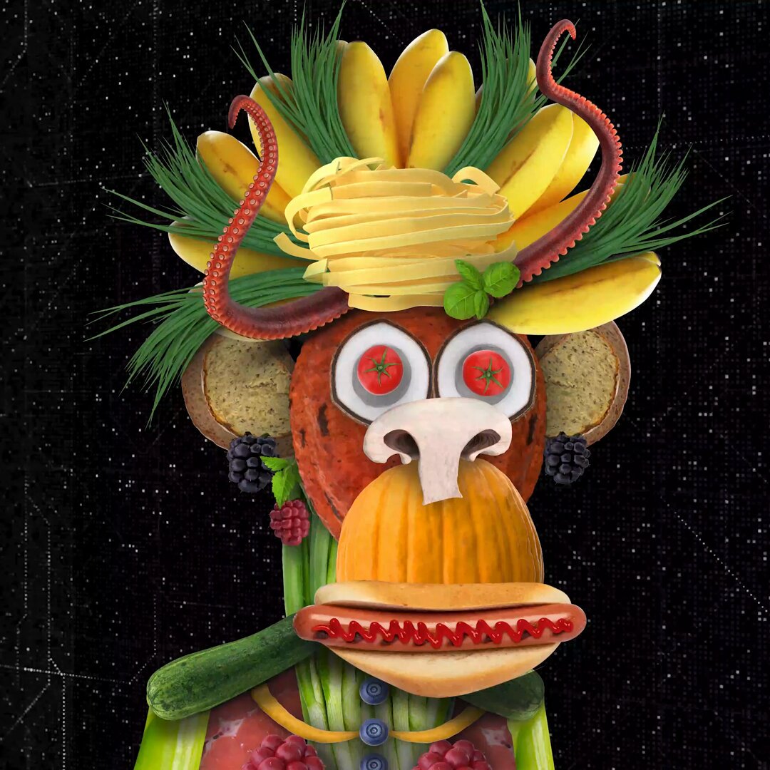 The image features a monkey wearing a hat made out of fruit and vegetables, including bananas, grapes, and cucumbers. The monkey appears to be holding a hot dog with mustard and ketchup. The background of the image is black, which contrasts with the colorful elements on the monkey's head and face. The caption reads: "Hi lovely friend! And thank you @hamid_tna for tagging me! I will share a historic piece, the first food ape in the space, an animated collage of my food photos, exhibited in many famous places."