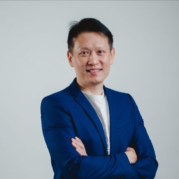 A professional headshot of Binance CEO Richard Teng shows him smiling in a navy blazer against a light background. The image accompanies a post about his warning to Europe regarding fragmented MiCA implementation potentially driving away crypto users, firms, and tax revenue.