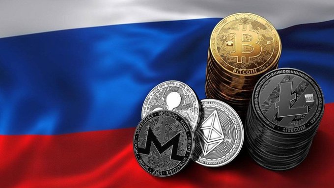 A collection of cryptocurrency coins (Bitcoin, Litecoin, Ethereum, and Monero) displayed in front of a Russian flag.