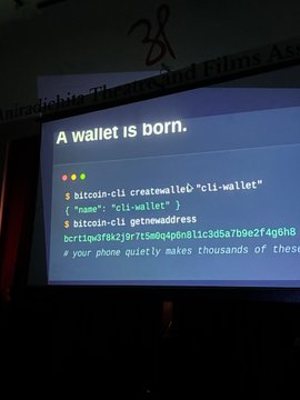 A presentation slide titled 'A wallet is born.' shows terminal code creating a 'cli-wallet' directory and generating a new blockchain address using bitcoin-cli.