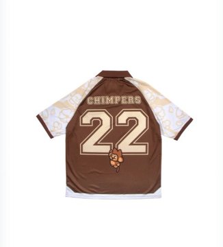 A brown and white sports-style jersey laid flat, featuring the word 'CHIMPERS', the number '22', and a small cartoon character on the chest.